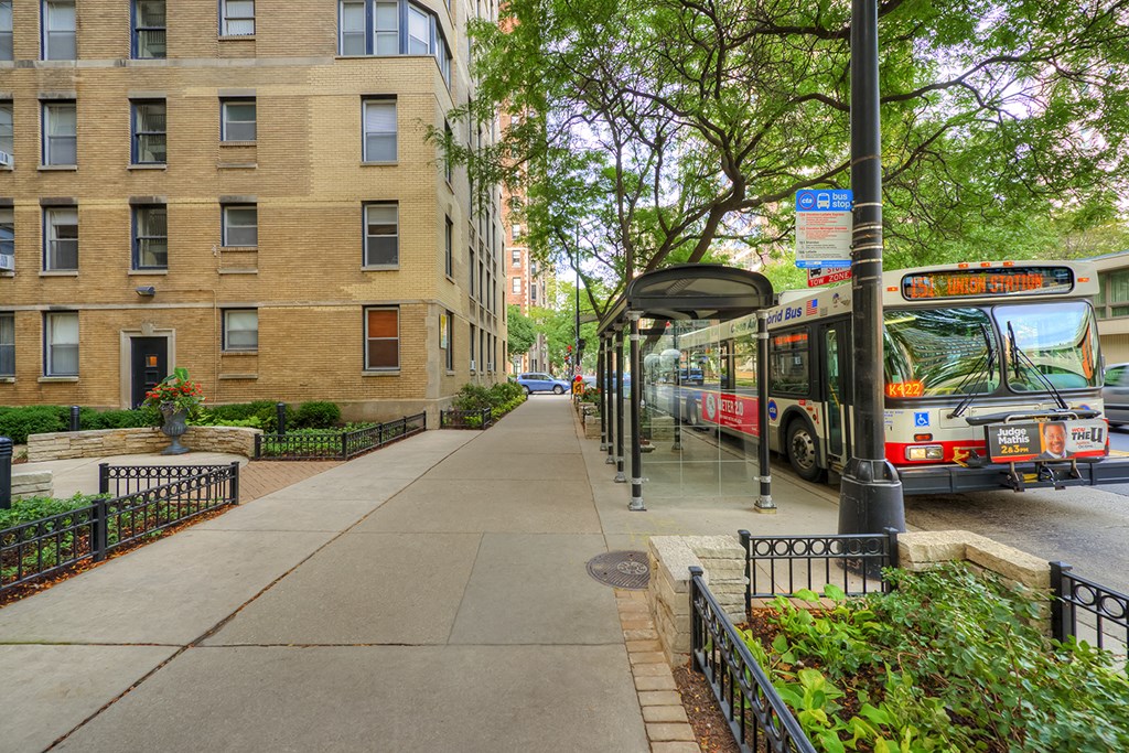 a city bus is parked at a bus stop
