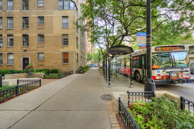 a bus stopped at a bus stop on a city street