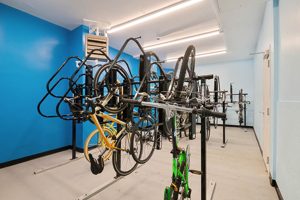 a room with several bikes hanging on a rack
