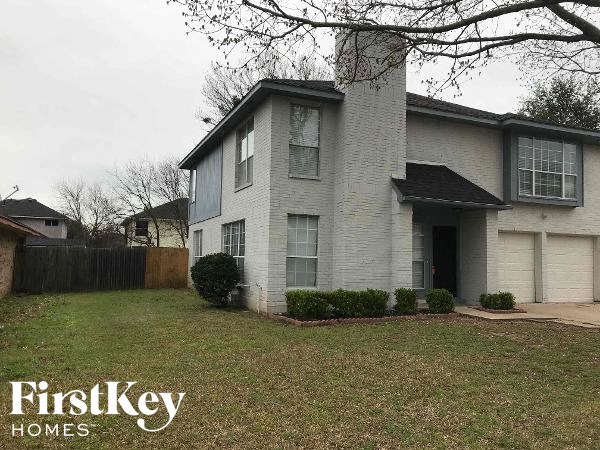 a white house with a yard in front of it