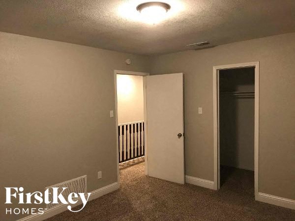 a empty room with a hallway and a door