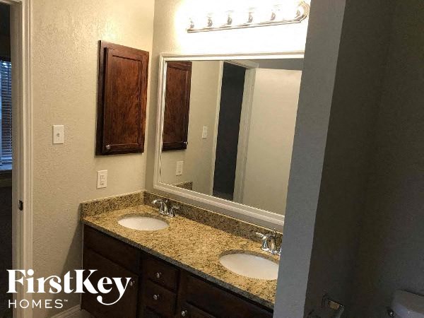a bathroom with two sinks and a mirror