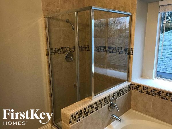 a small bathroom with a shower and a sink