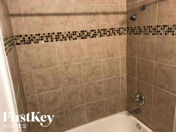 a bathroom with a shower and a bath tub