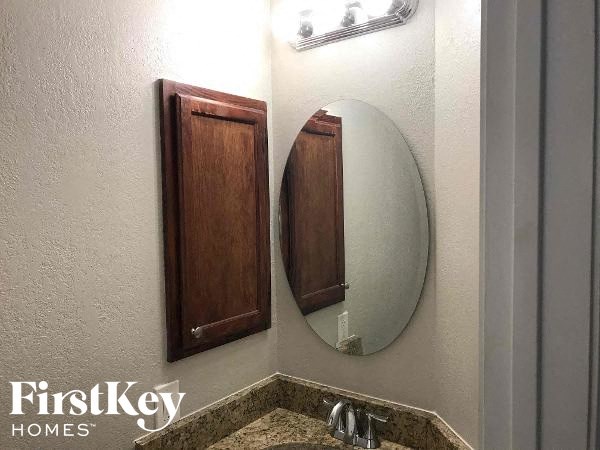 a bathroom with a mirror and a sink