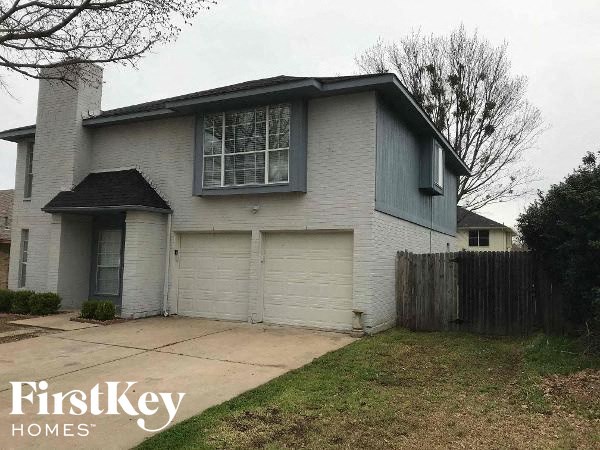 a white house with a sidewalk in front of it