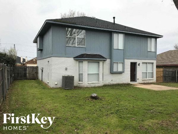 a blue and white house in a grass yard
