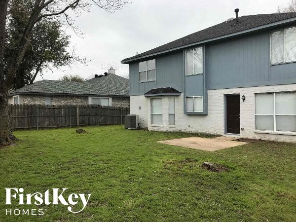 a blue and white house in a grass yard