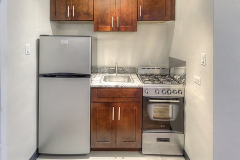a kitchen with a stove and refrigerator and a sink