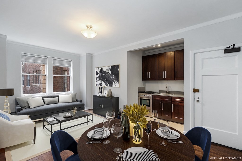 a living room and kitchen with a table and chairs