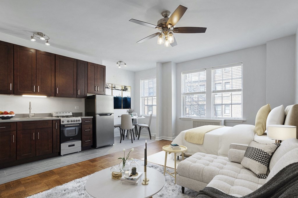 a living room with a couch and a ceiling fan