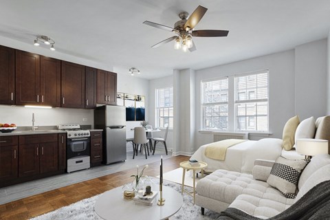a living room with a couch and a ceiling fan