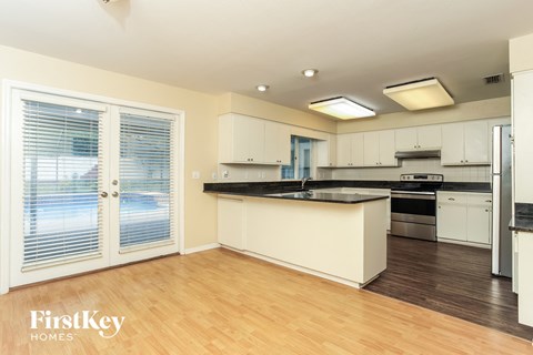 A kitchen with a counter top and a sink.