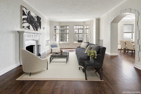 a living room with a couch and a chair and a fireplace