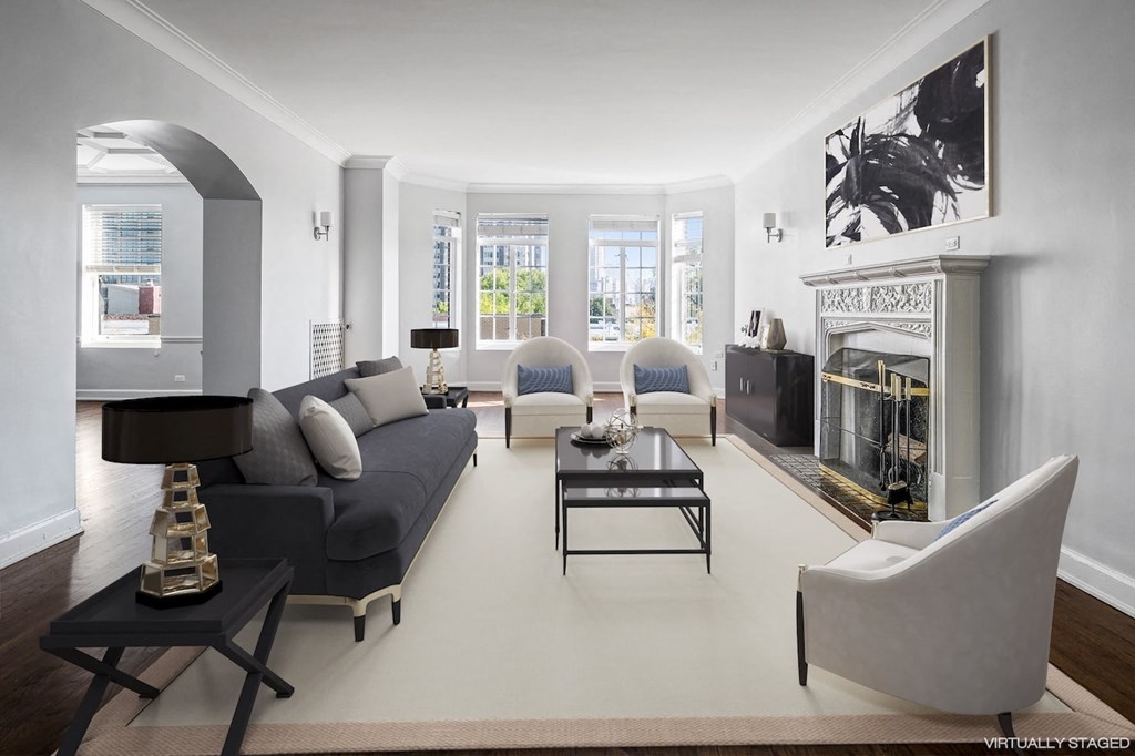 a living room with a couch and chairs and a fireplace