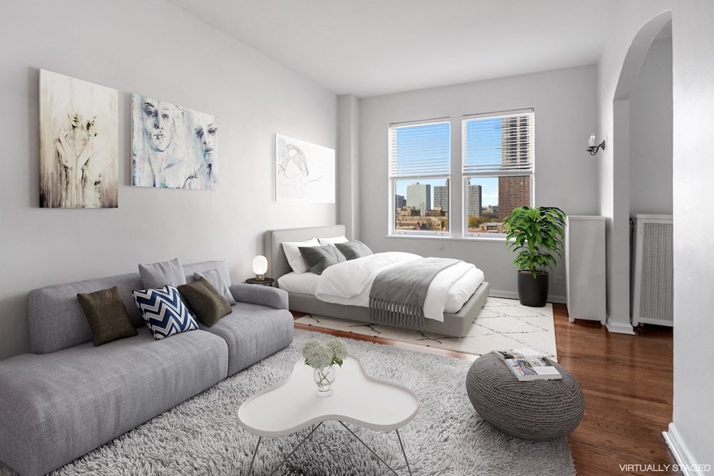 a bedroom with a bed and a couch and a rug