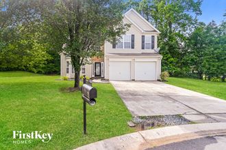 a house with a driveway and a parking meter in front of it