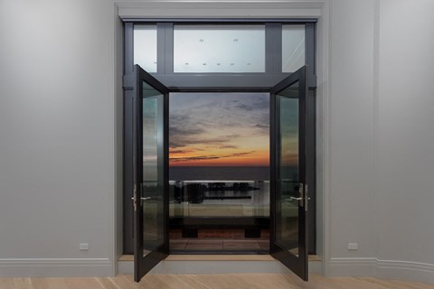 a view of the sunset through a glass door