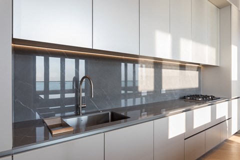 a kitchen with white cabinets and a sink