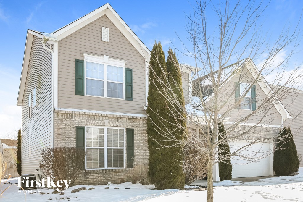 A house with a snowy front yard.