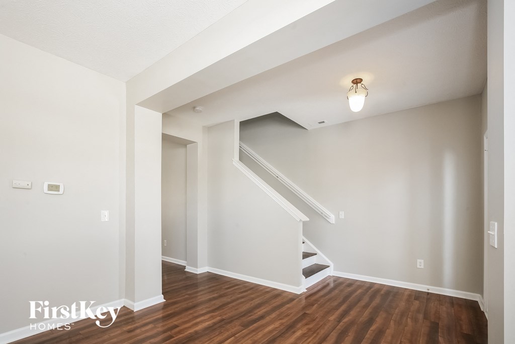 A staircase in a house with a light bulb hanging from the ceiling.