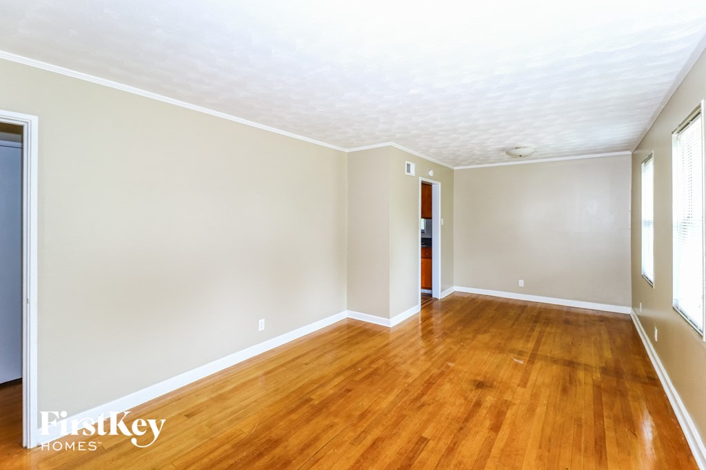 A room with wooden floors and white walls.