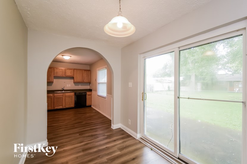 A view of a kitchen from a hallway with a First Key Homes logo.