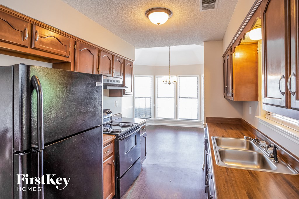 a kitchen with black appliances and wooden cabinets