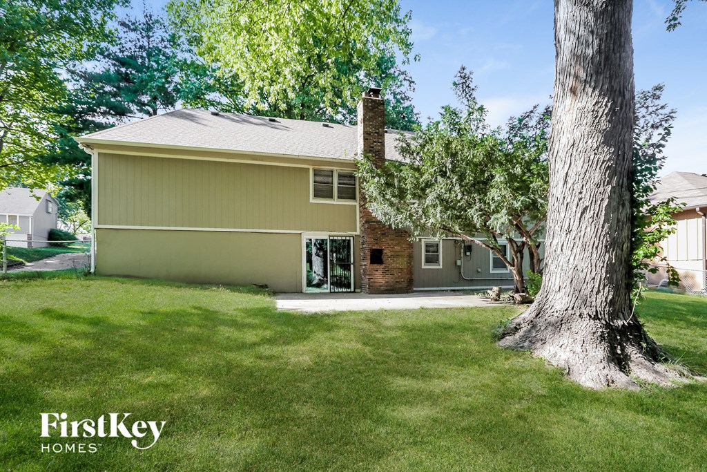 a home with a large tree in the yard