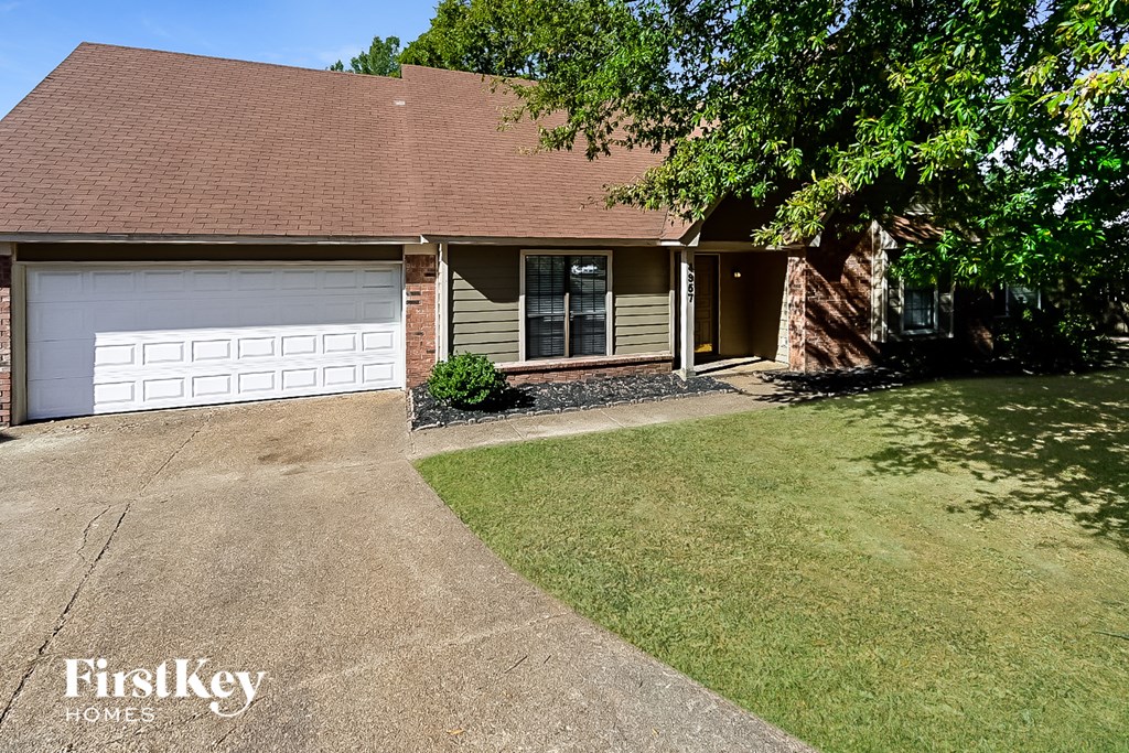 A house with a brown roof and a white garage door.