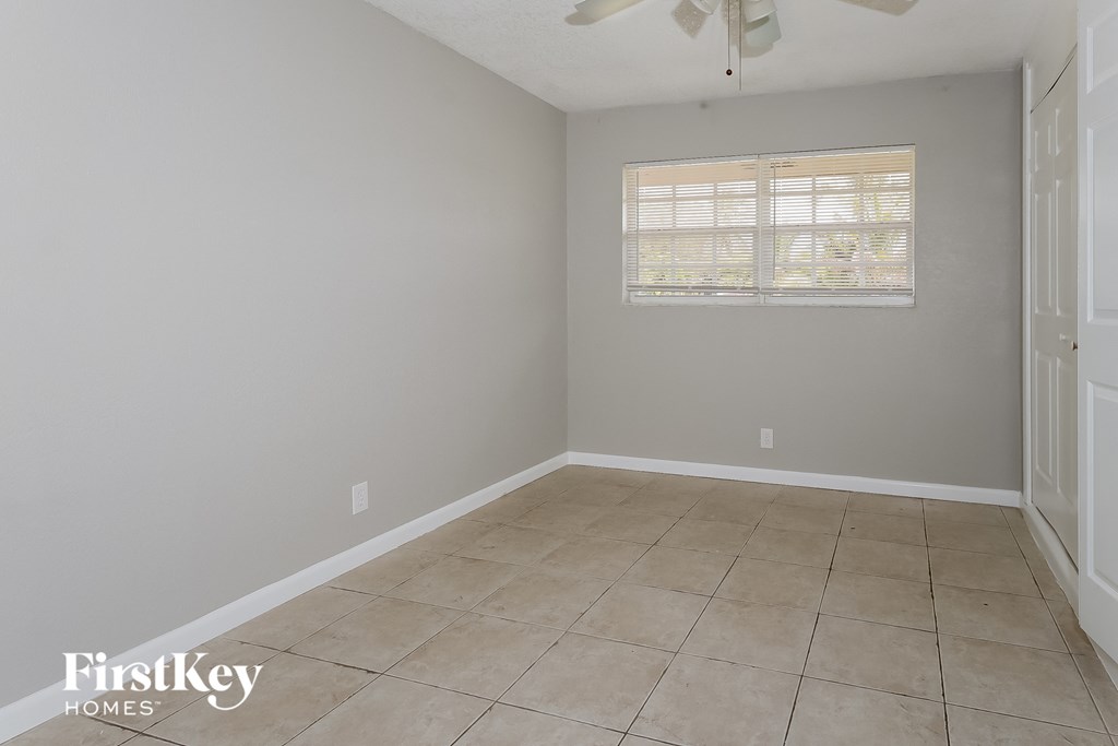 a empty room with a window and a tiled floor