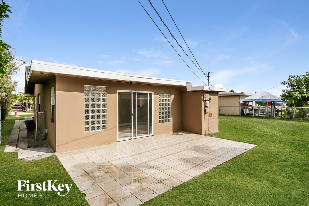 a small house with a patio and a yard