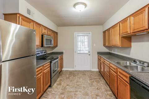 the kitchen is clean and ready to use with stainless steel appliances and wooden cabinets