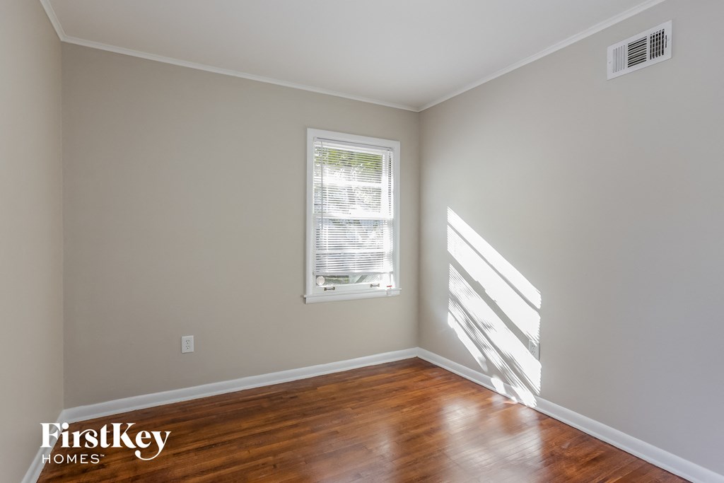 a living room with wood floors and a window