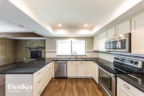 A kitchen with a stove top oven and a dishwasher.