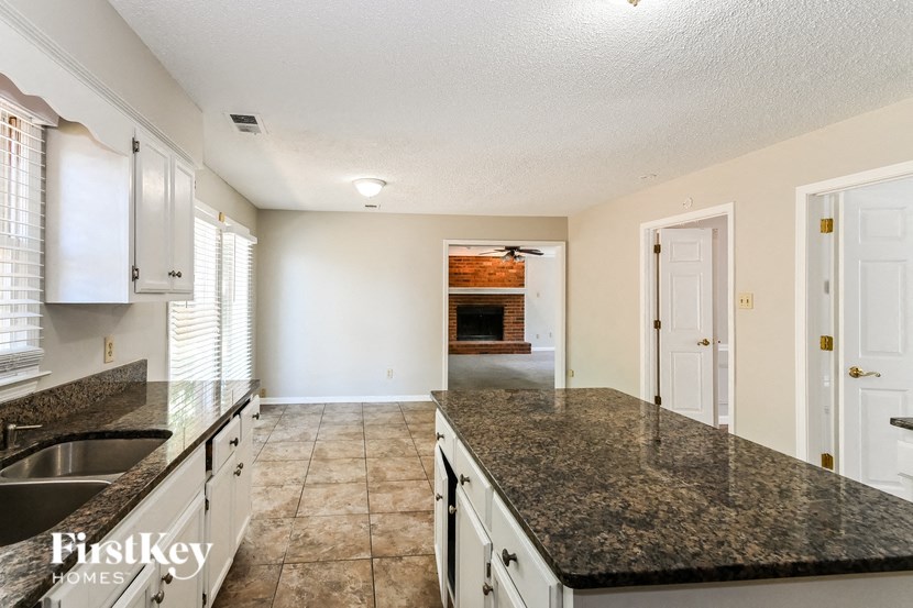 a kitchen with granite counter tops and a fireplace