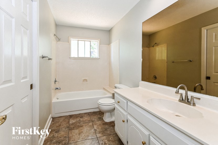 a bathroom with a sink and a toilet and a tub
