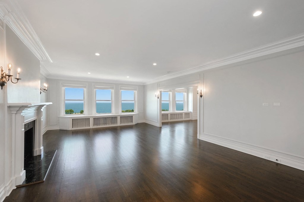 a living room with a fireplace and hardwood floors