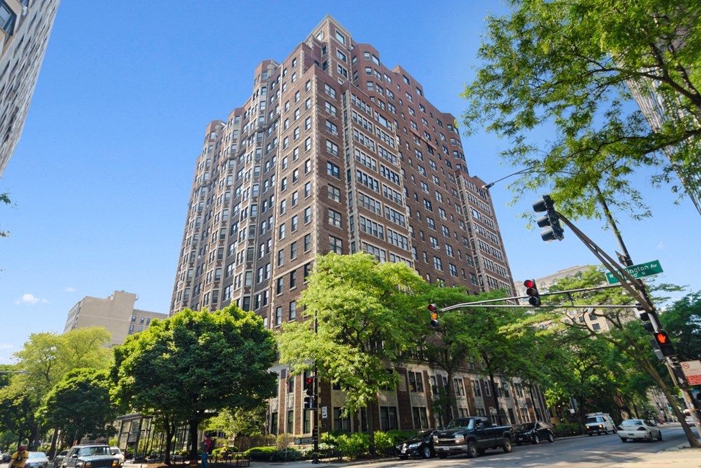 a tall apartment building on the corner of a city street