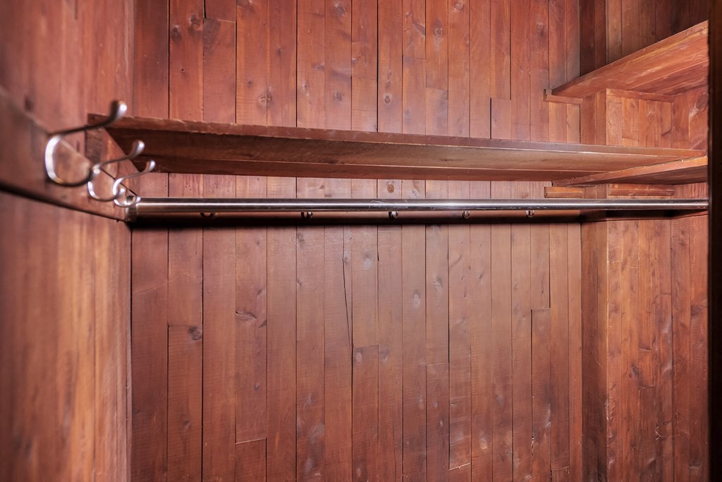 a wooden wall with a bar and a pair of scissors on it