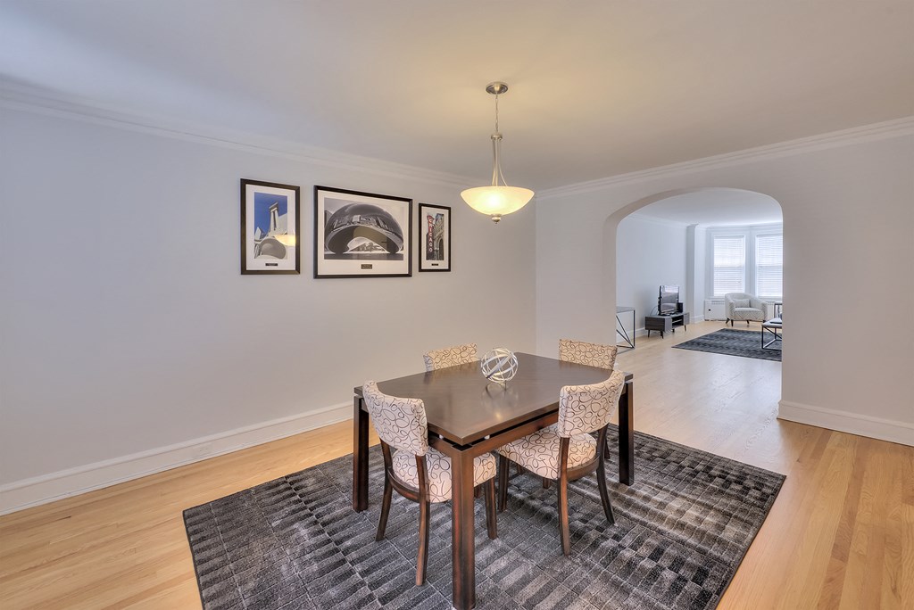 a dining room with a wooden table and chairs