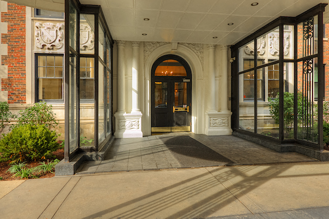 the front entrance of a building with a black door