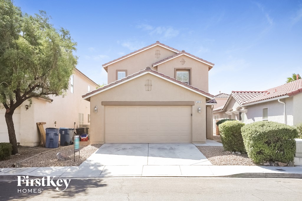 a house with a driveway and a garage door