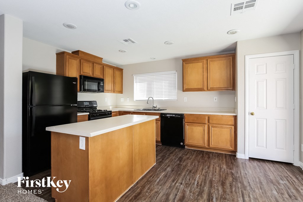 a kitchen with wooden cabinets and a white counter top