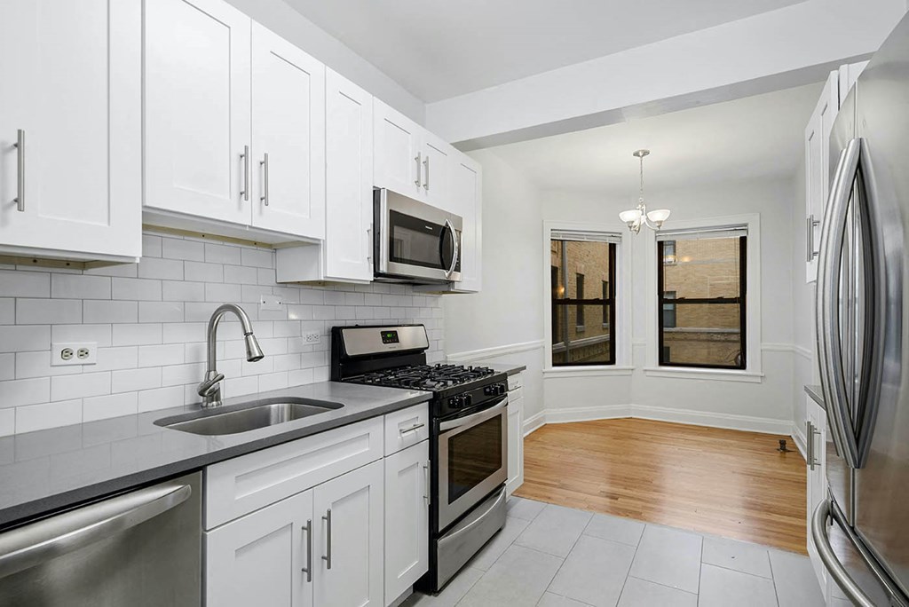 a kitchen with stainless steel appliances and white cabinets