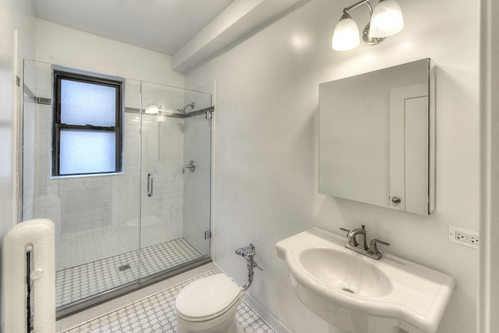 a bathroom with a sink toilet and shower