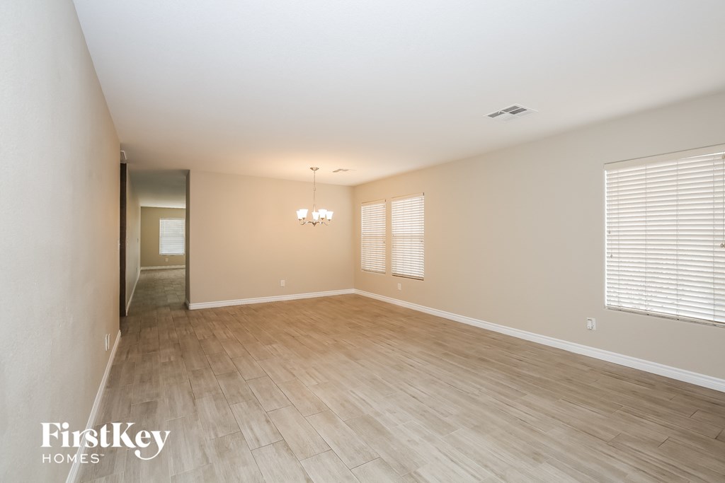 a spacious living room with wood floors and a large window