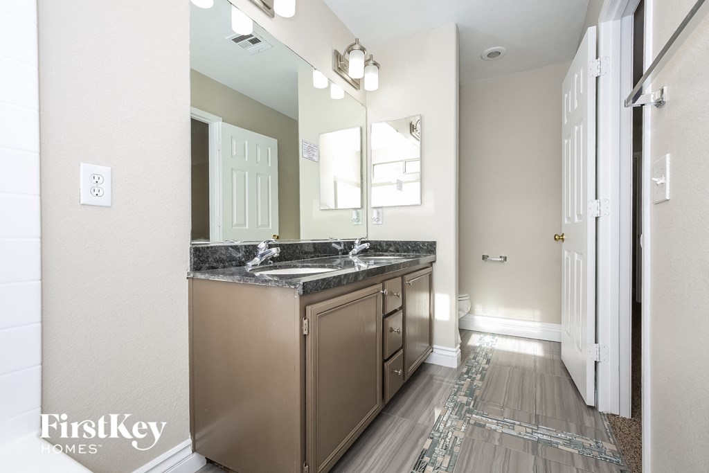 an empty bathroom with a sink and a mirror