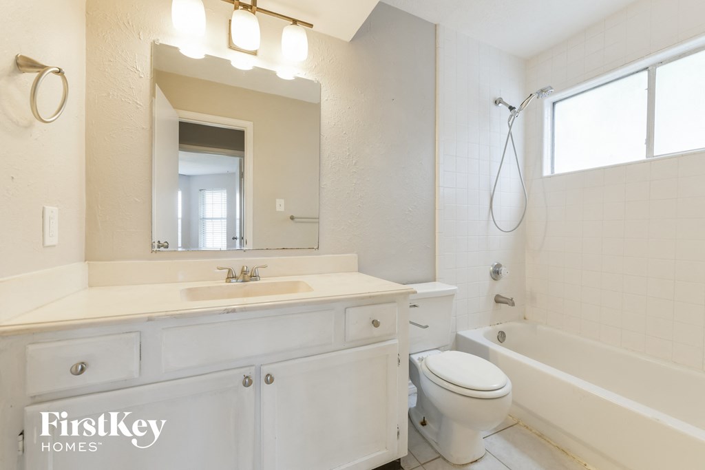 a bathroom with a sink toilet and a bath tub