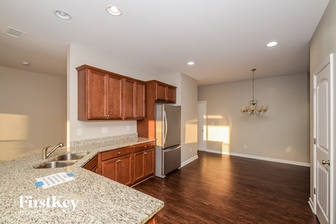 A kitchen with wooden cabinets and a granite countertop.